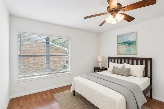 a bedroom with a large bed and a window