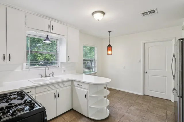 a kitchen that has a sink and a stove