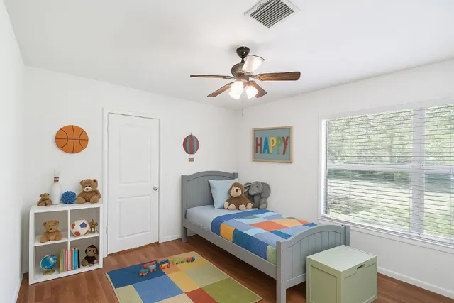 a bedroom with a bed and a window