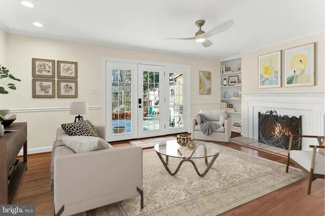an empty room with wooden floor and a fireplace