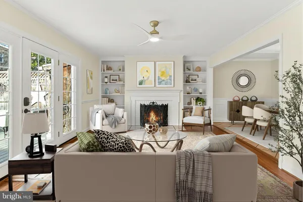 a view of an empty room with wooden floor fireplace and a window