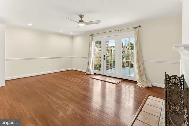 a view of a livingroom with wooden floor a fireplace and window