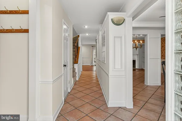 a kitchen with stainless steel appliances granite countertop a stove top oven a refrigerator and a dining table