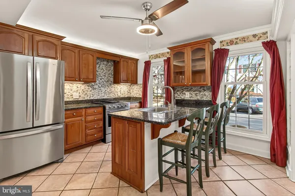 a stove top oven sitting inside of a kitchen