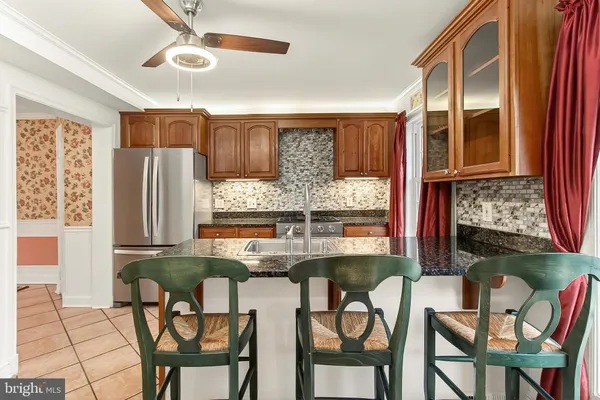 a stove top oven sitting inside of a kitchen