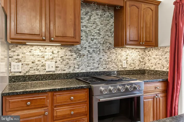 a stove top oven sitting inside of a kitchen
