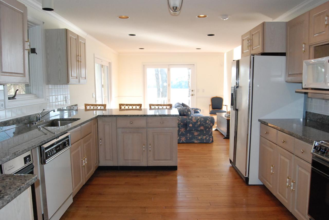 151 Hupi Road Monterey, MA 01245 - Photo 17 of 31 a kitchen with stainless steel appliances a sink a stove a refrigerator cabinets and a large window