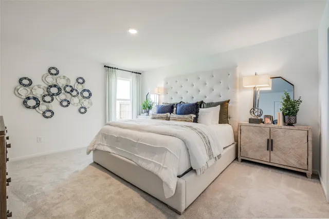 a spacious bedroom with a bed and window