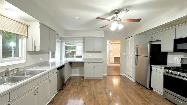 a kitchen with a sink stainless steel appliances a window and a counter top space