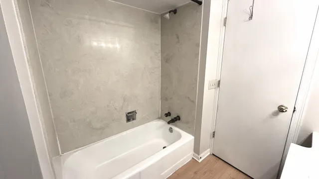 a bathroom with a bathtub and shower