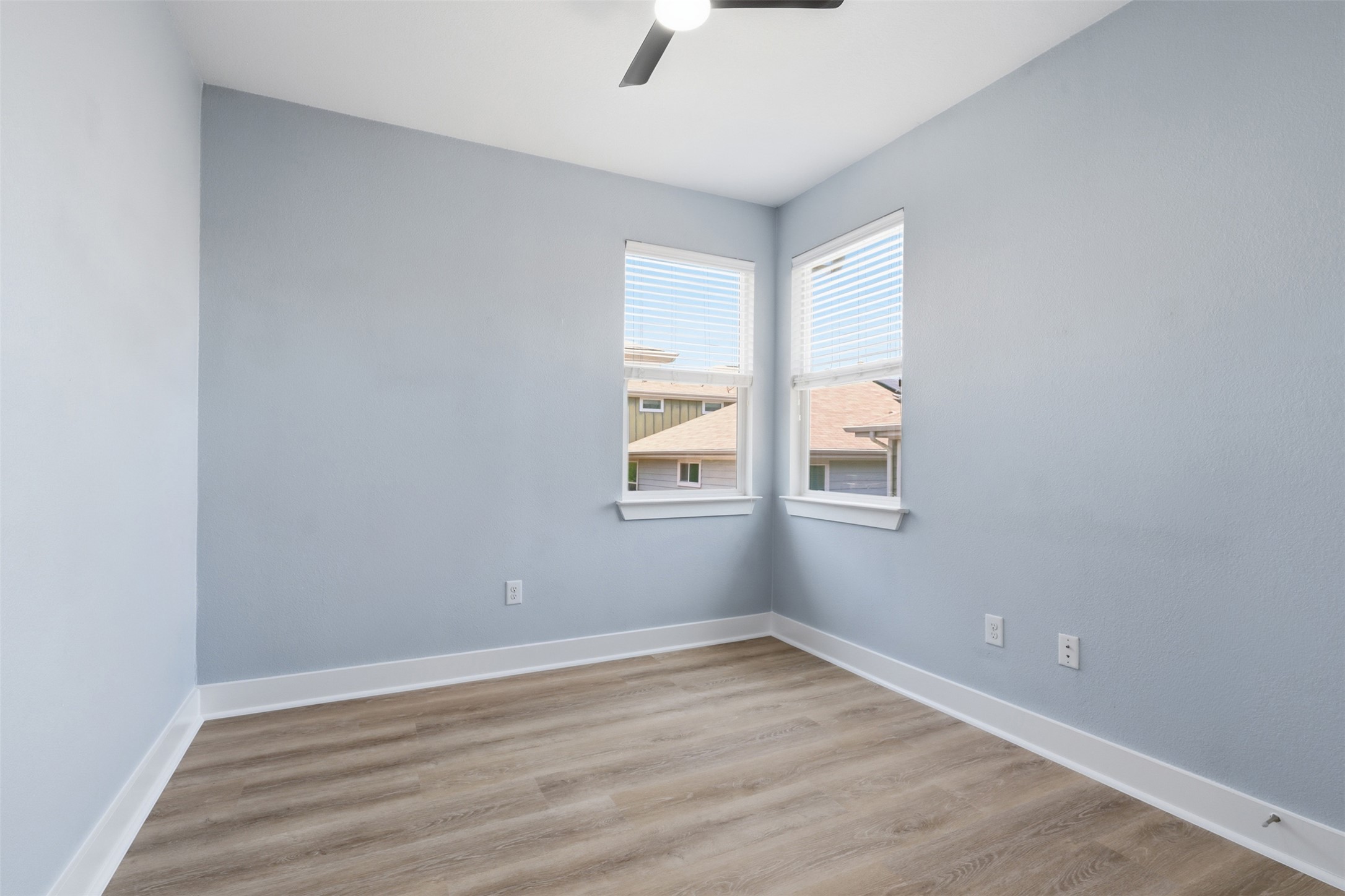 7208 Lysander Court Austin, TX 78741 - Photo 12 of 15 an empty room with wooden floor and windows