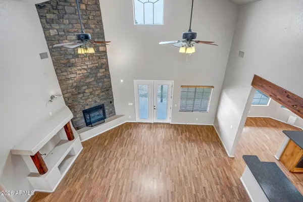 a kitchen with stainless steel appliances granite countertop a refrigerator a sink dishwasher a stove with wooden cabinets and floor