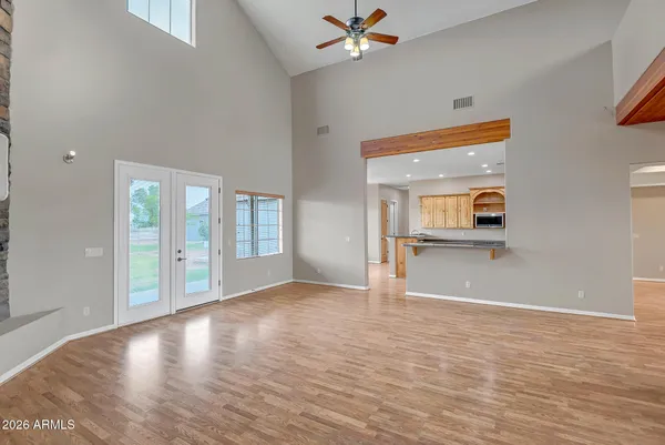 a view of a kitchen with kitchen island a large window a sink and counter space