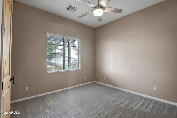 a kitchen with a refrigerator and a stove top oven with wooden floor