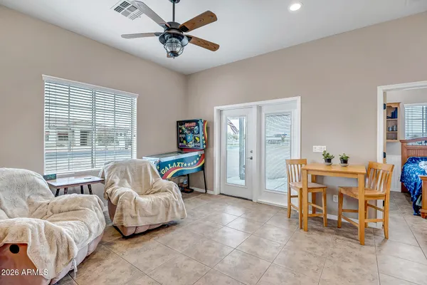 a view of pool with lawn chairs under an umbrella