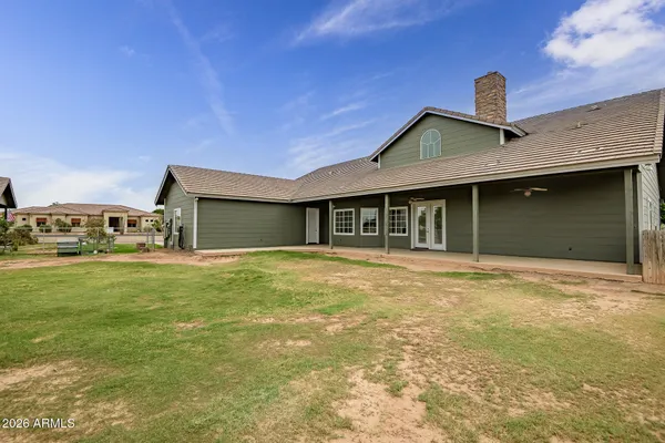 an empty room with windows and fireplace
