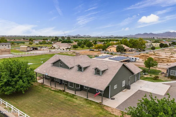 a view of a livingroom with wooden floor and a fireplace