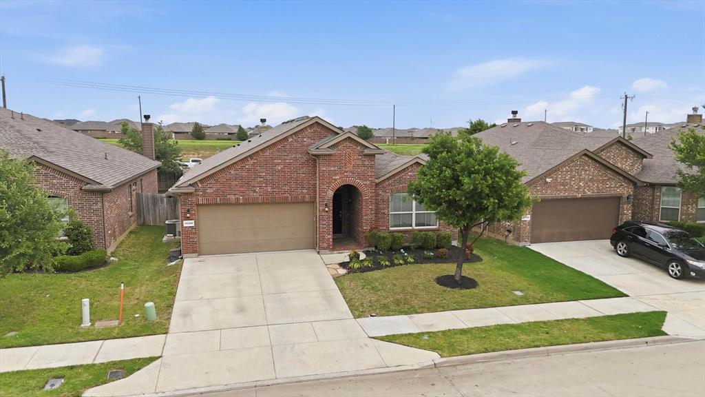 11500 Starlight Ranch Fort Worth, TX 76052 - Photo 36 of 40 The property features a brick exterior, an attached garage, and a well-maintained lawn