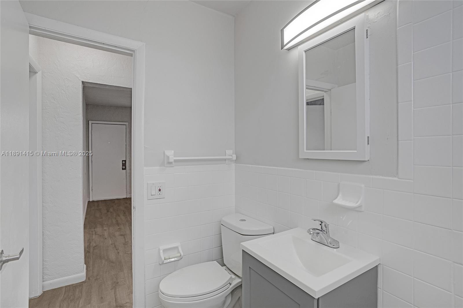 14120 Northwest 24th Court, Unit 304 Opa-Locka, FL 33054 - Photo 17 of 21 a bathroom with a sink toilet and vanity