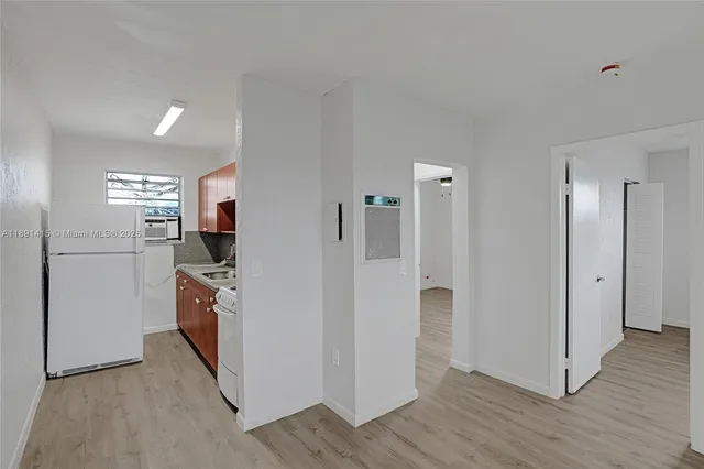 a kitchen with stainless steel appliances a refrigerator and a stove top oven