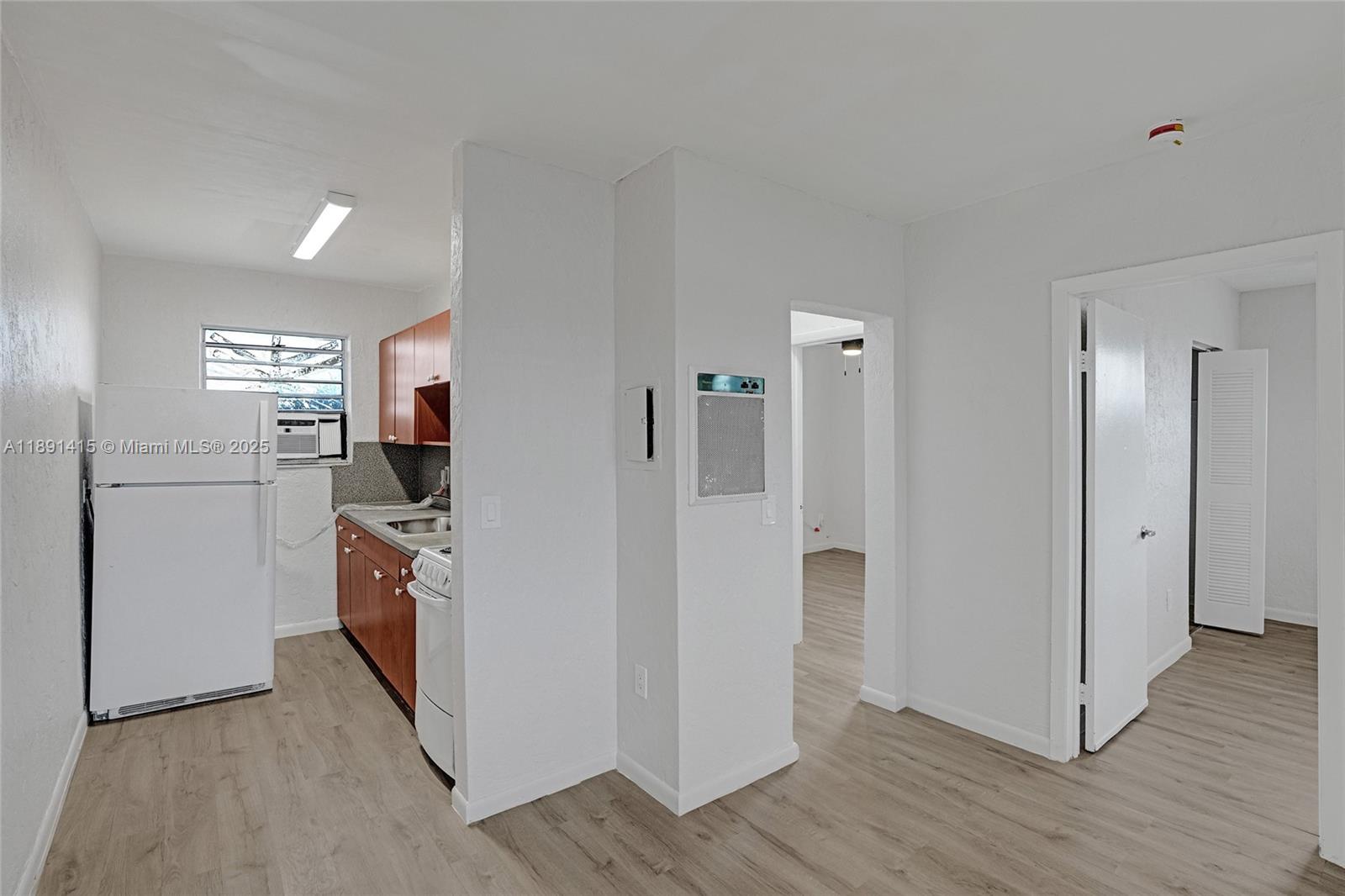 14120 Northwest 24th Court, Unit 304 Opa-Locka, FL 33054 - Photo 10 of 21 a kitchen with stainless steel appliances a refrigerator and a stove top oven