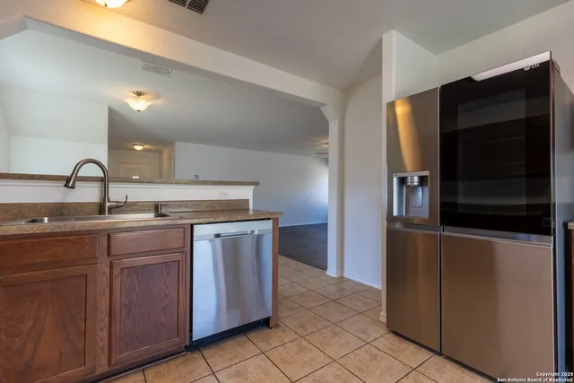 a kitchen with a sink and a refrigerator