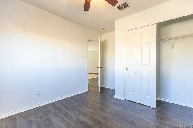 an empty room with wooden floor
