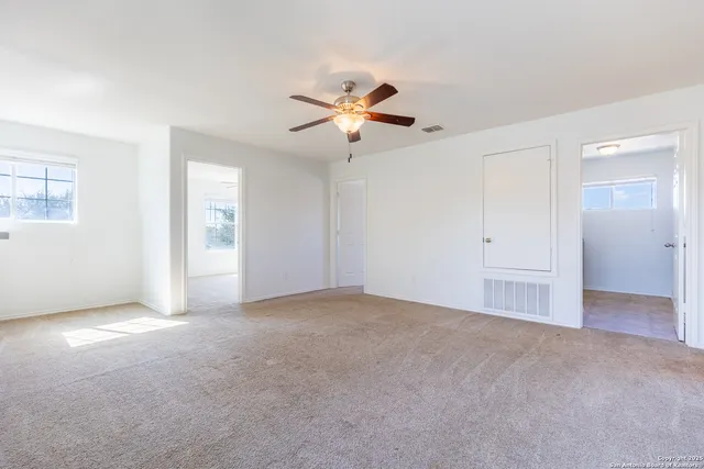 a view of empty room with ceiling fan