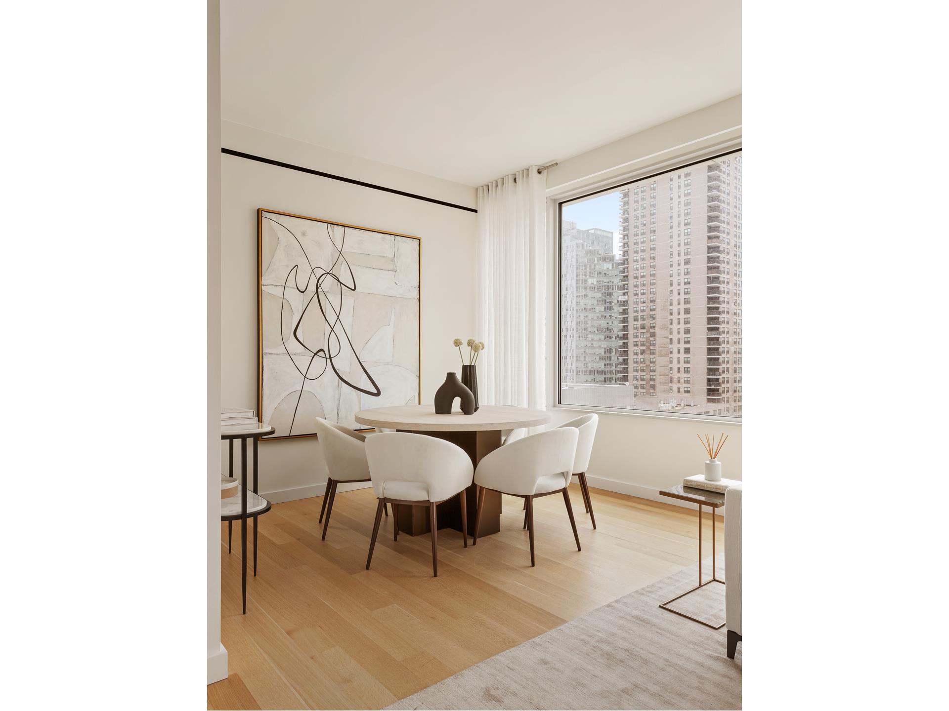 611 West 56th Street, Unit 12 Manhattan, NY 10019 - Photo 10 of 24 a dining room with furniture and window