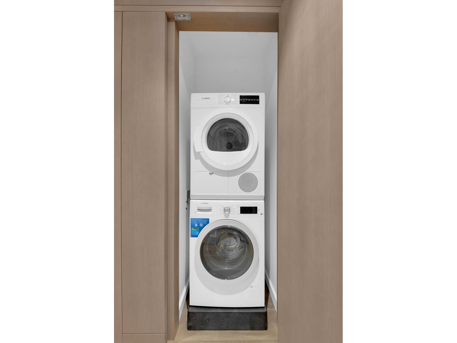 611 West 56th Street, Unit 12 Manhattan, NY 10019 - Photo 13 of 24 a utility room with dryer and washer