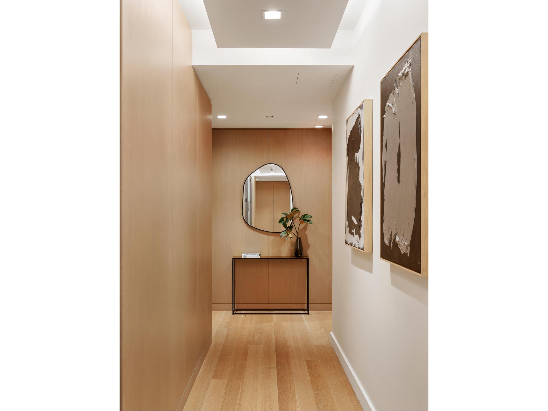 611 West 56th Street, Unit 12 Manhattan, NY 10019 - Photo 2 of 24 a bedroom with a bed and a mirror