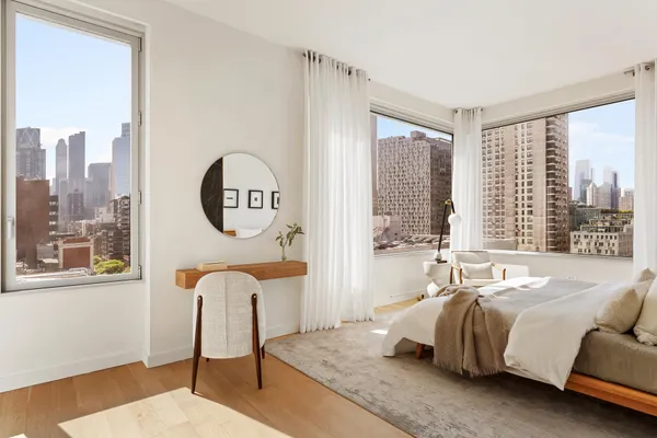 a bedroom with a bed and a mirror