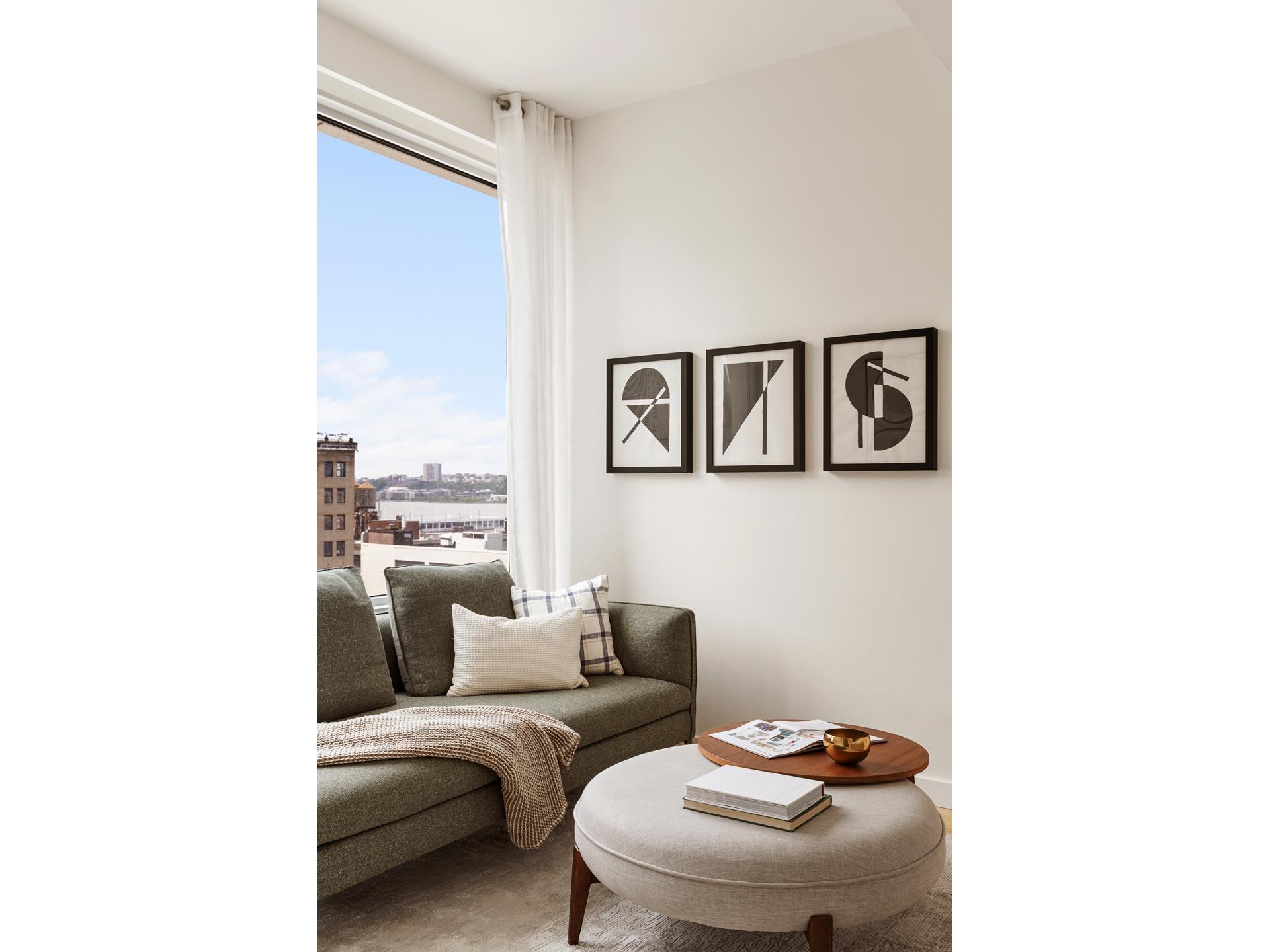 611 West 56th Street, Unit 12 Manhattan, NY 10019 - Photo 8 of 24 a living room with furniture and a white wall