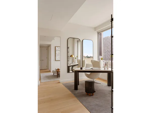 a living room with furniture and a white wall