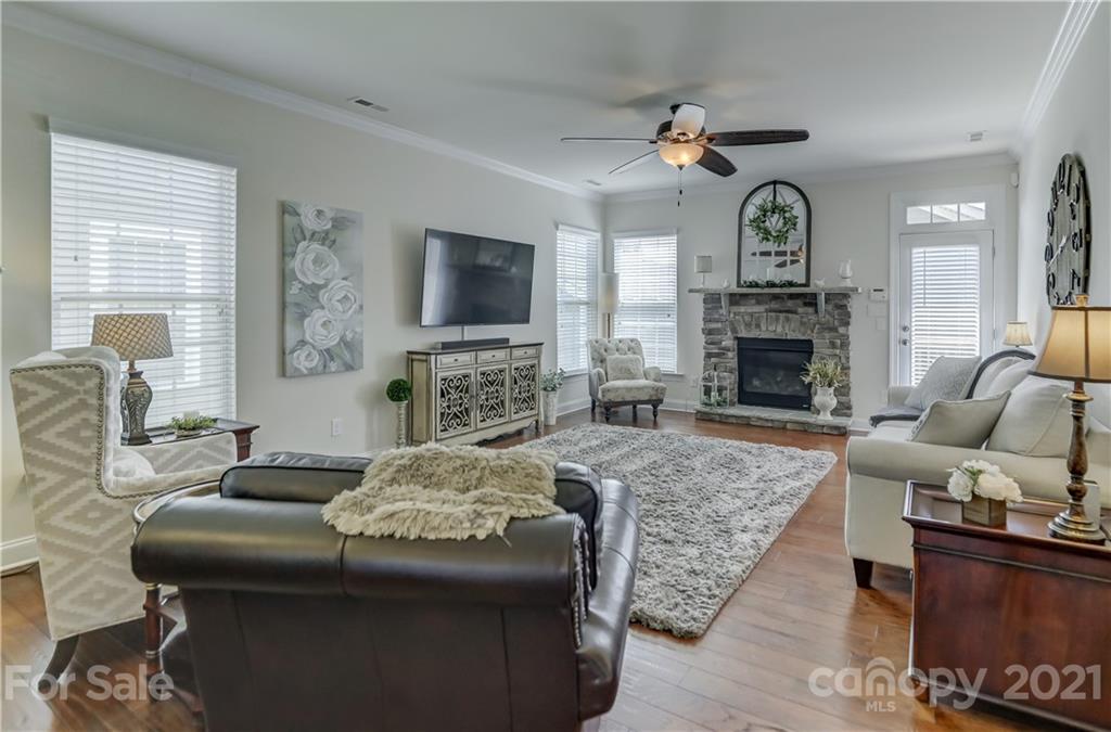 2016 Henslow Trail Tega Cay, SC 29708 - Photo 11 of 33 a living room with furniture a fireplace and a flat screen tv