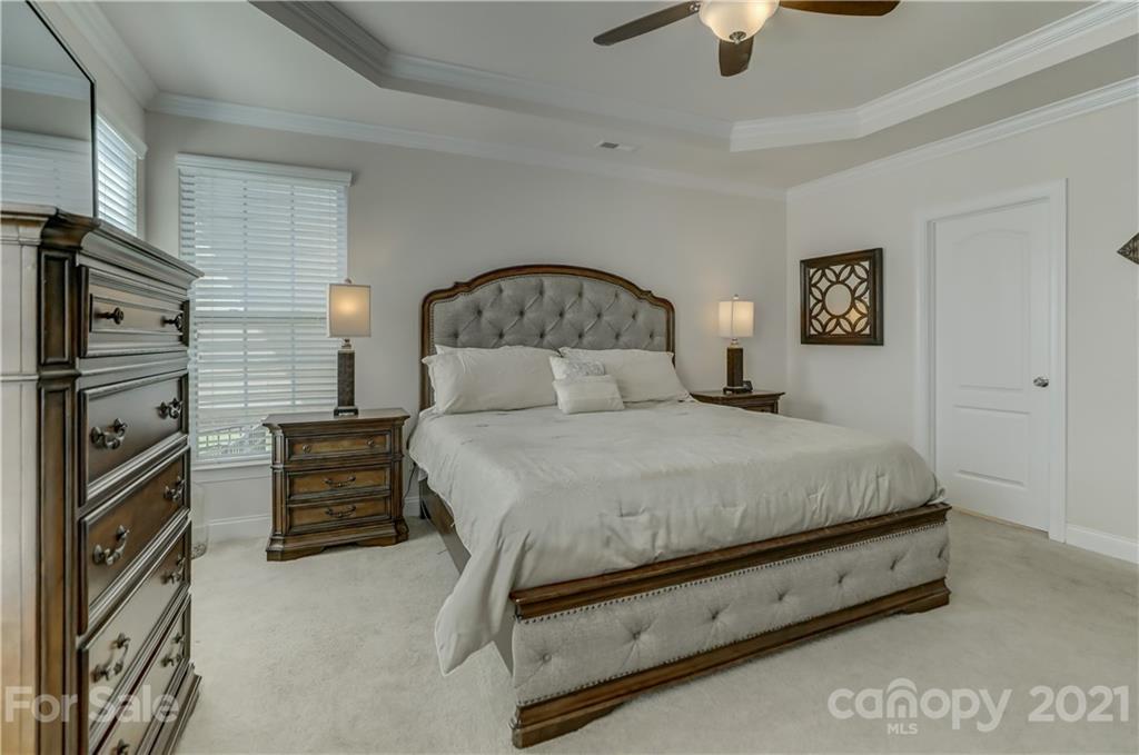 2016 Henslow Trail Tega Cay, SC 29708 - Photo 15 of 33 a spacious bedroom with a bed and a chandelier