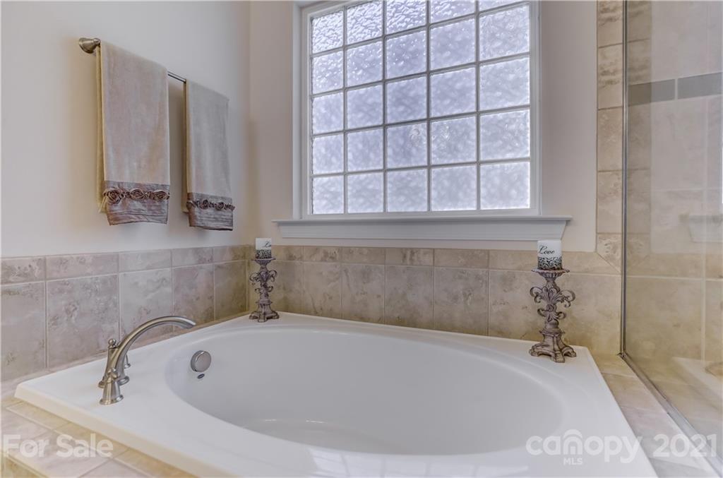 2016 Henslow Trail Tega Cay, SC 29708 - Photo 17 of 33 a white bath tub sitting in a bathroom