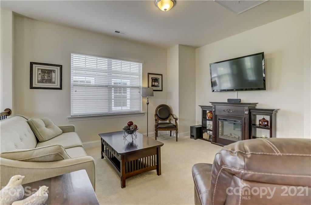 2016 Henslow Trail Tega Cay, SC 29708 - Photo 23 of 33 a living room with furniture a fireplace and a flat screen tv