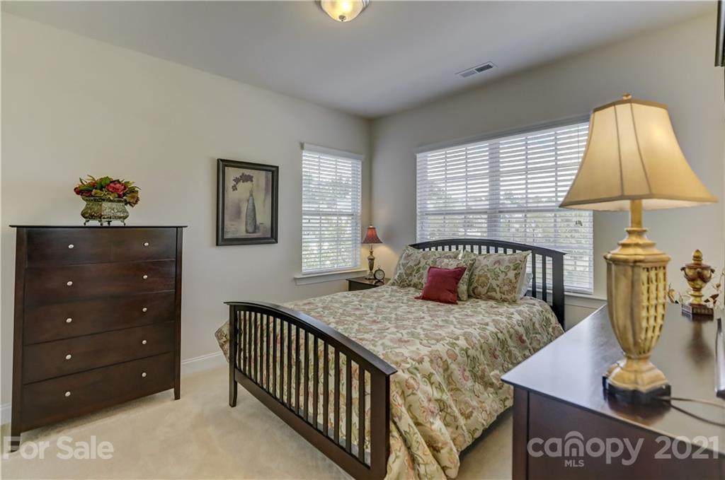 2016 Henslow Trail Tega Cay, SC 29708 - Photo 24 of 33 a bedroom with a bed and a table