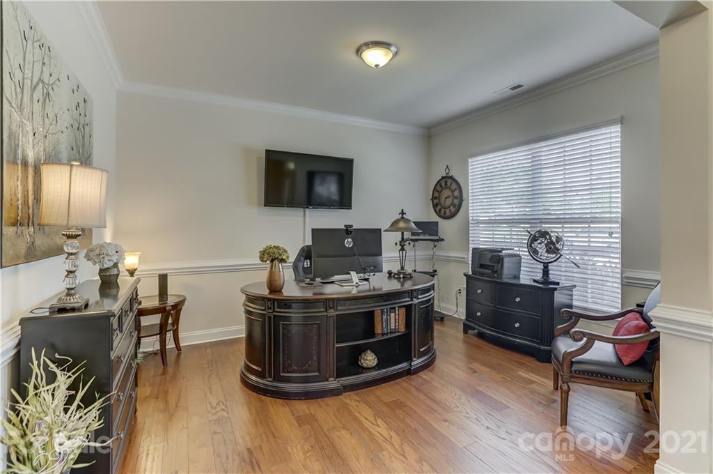 2016 Henslow Trail Tega Cay, SC 29708 - Photo 4 of 33 a view of a workspace with furniture and a flat screen tv