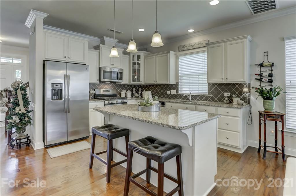 2016 Henslow Trail Tega Cay, SC 29708 - Photo 5 of 33 a kitchen with kitchen island granite countertop a sink cabinets and stainless steel appliances