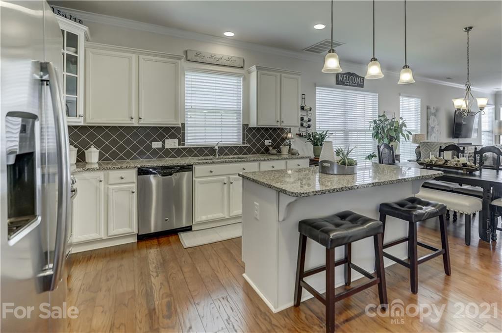 2016 Henslow Trail Tega Cay, SC 29708 - Photo 6 of 33 a kitchen with stainless steel appliances granite countertop a stove a sink dishwasher and a refrigerator with wooden floor