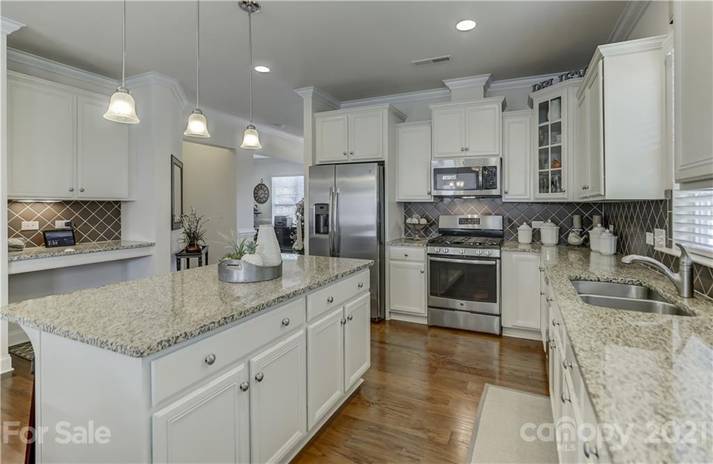 2016 Henslow Trail Tega Cay, SC 29708 - Photo 7 of 33 a kitchen with stainless steel appliances granite countertop a sink a stove and a refrigerator
