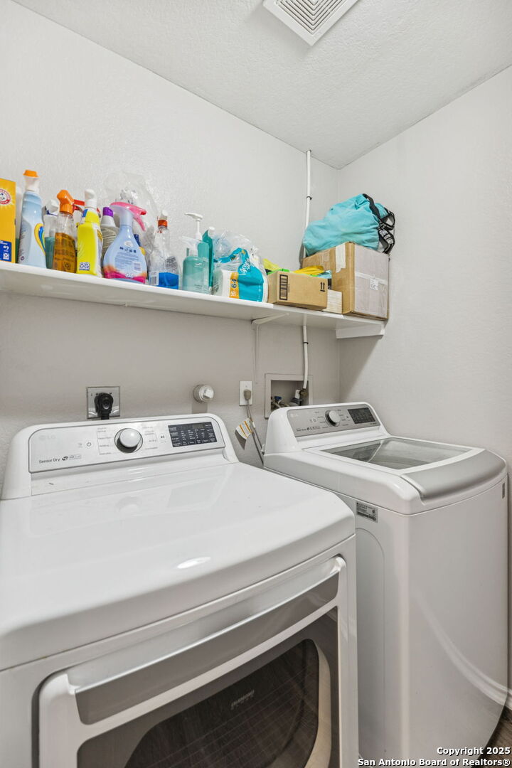 8919 Kestrel Oak Converse, TX 78109 - Photo 11 of 24 a utility room with dryer and washer