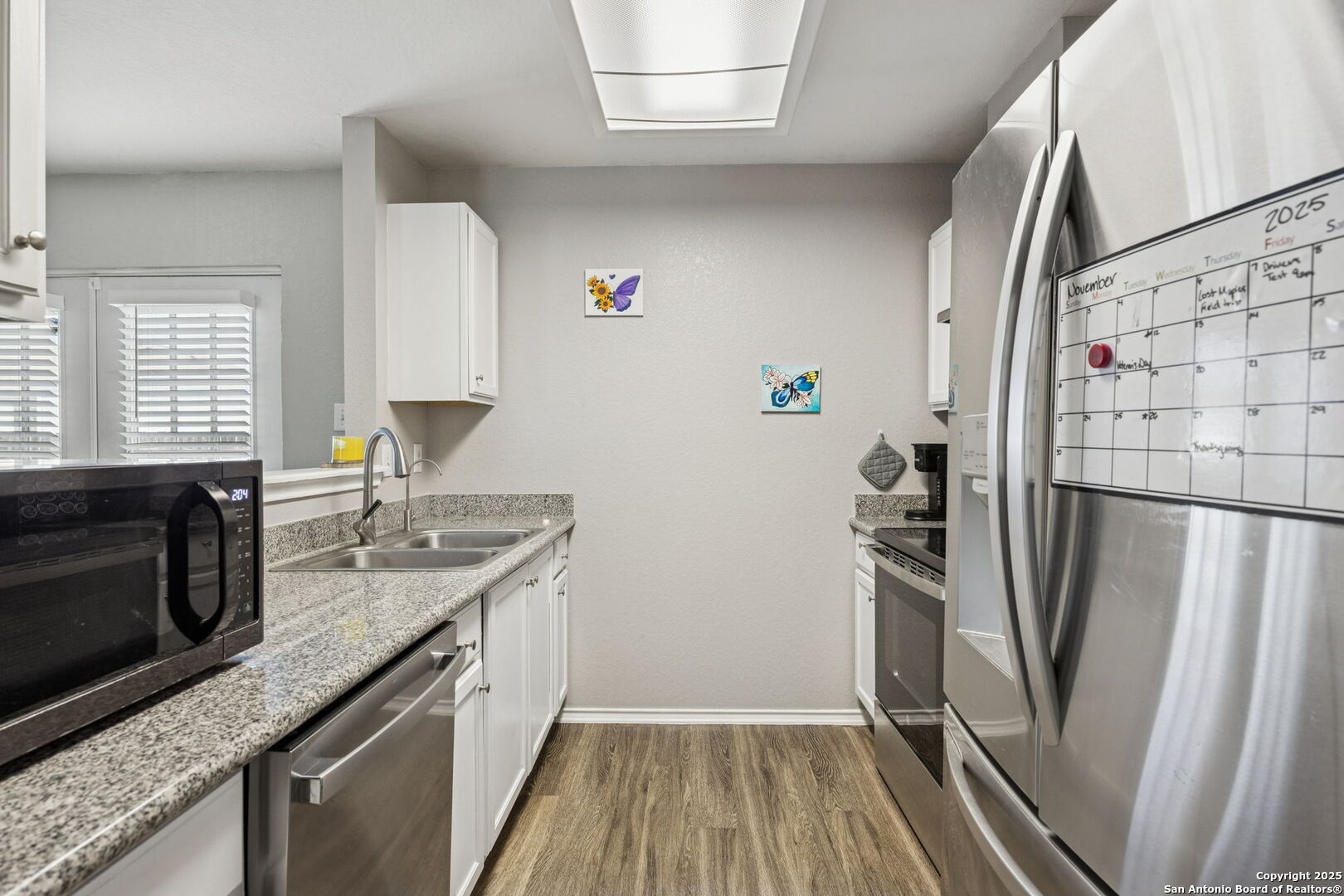 8919 Kestrel Oak Converse, TX 78109 - Photo 9 of 24 a kitchen with stainless steel appliances granite countertop a refrigerator a stove and a sink