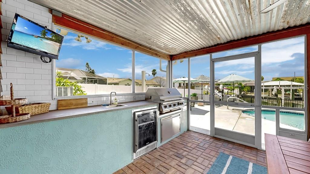 1004 Sago Palm Way Apollo Beach, FL 33572 - Photo 16 of 25 a kitchen with stainless steel appliances granite countertop a stove a sink and cabinets