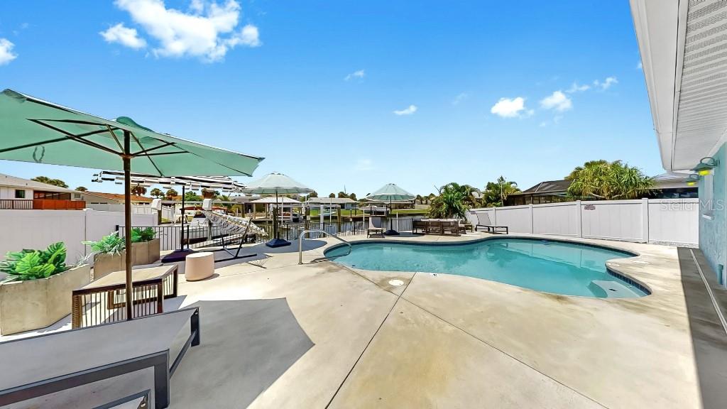 1004 Sago Palm Way Apollo Beach, FL 33572 - Photo 20 of 25 a view of a swimming pool and lounge chairs