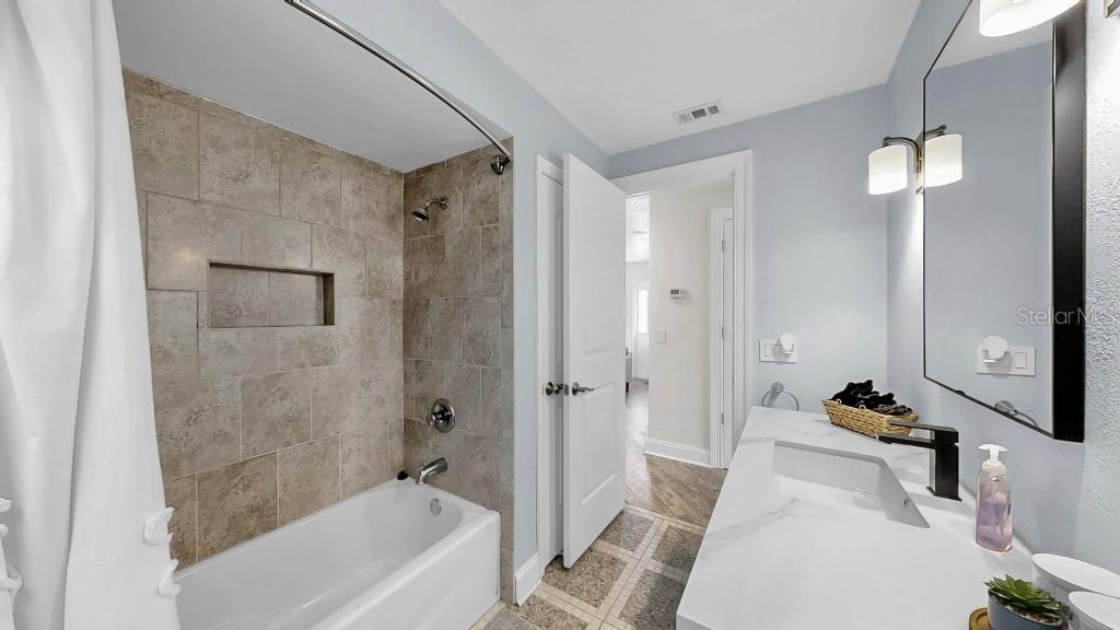 1004 Sago Palm Way Apollo Beach, FL 33572 - Photo 21 of 25 a bathroom with a tub shower sink and mirror