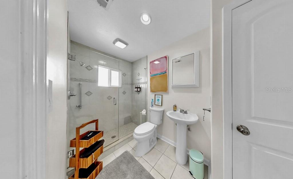 1004 Sago Palm Way Apollo Beach, FL 33572 - Photo 22 of 25 a bathroom with a toilet sink and shower