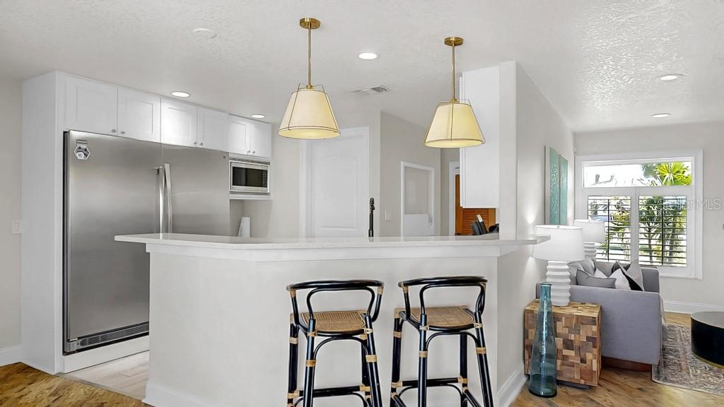 1004 Sago Palm Way Apollo Beach, FL 33572 - Photo 5 of 25 a kitchen with cabinets and chandelier